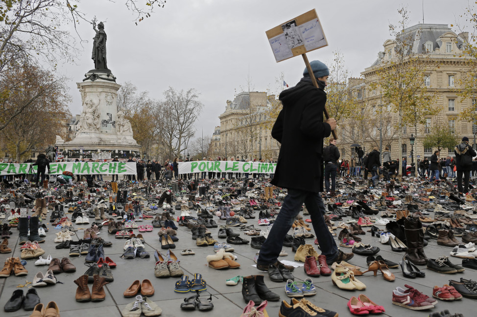 A man walks hundreds of pairs of shoes that are displayed at the place de la Republique, in Paris, as part of a symbolic and peaceful rally in Paris on Nov. 29, 2015.  (Reuters)