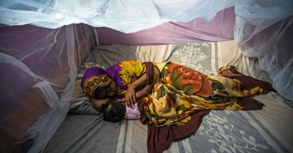 Habiba Suleiman, 29, a district malaria surveillance officer in Zanzibar, naps with her little girl Rahma under a mosquito net. She lives in Tanzania, where up to 80,000 people die from malaria each year. Hariba is working to change that. Read her story on USAID's storytelling hub. (photo courtesy of USAID)
