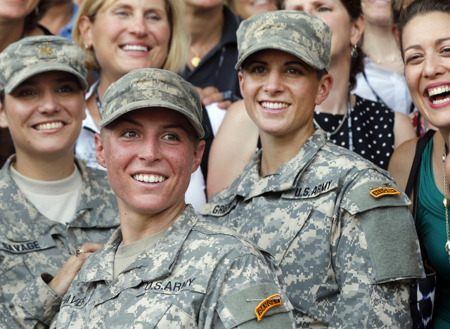 U.S. Army First Lt. Shaye Haver, center, and Capt. Kristen Griest, right, pose with other female West Point alumni after becoming the first women to graduate from Army Ranger school. Aug. 21, 2015, at Fort Benning, Ga. (AP)