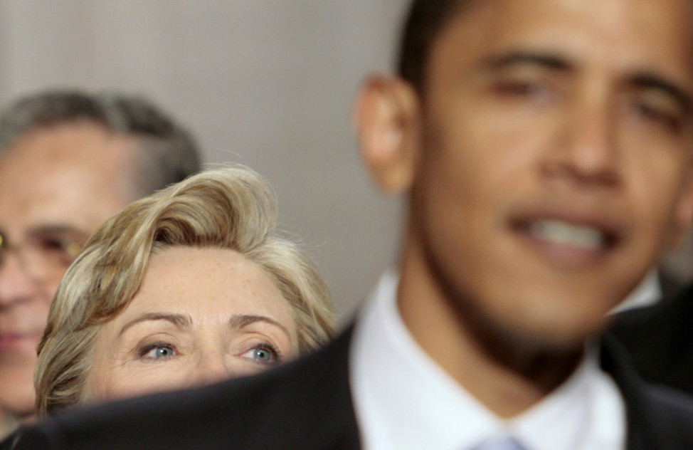 Then Senator Barack Obama stands in front of then Senator Hillary Clinton as they arrive for former President George W. Bush's annual State of the Union address at the U.S. Capitol in Washington January 23, 2007. (Reuters)