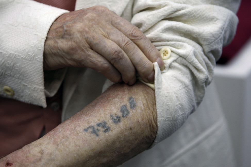 Polish-born Holocaust survivor Meyer Hack shows his prisoner number tattooed on his arm during at the Yad Vashem Holocaust Museum in Jerusalem in this June 2009 file photo. (Reuters) 