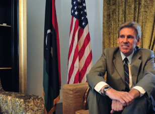 Christopher Stevens, the U.S. ambassador to Libya, smiles at his home in Tripoli June 28, 2012. (AP).