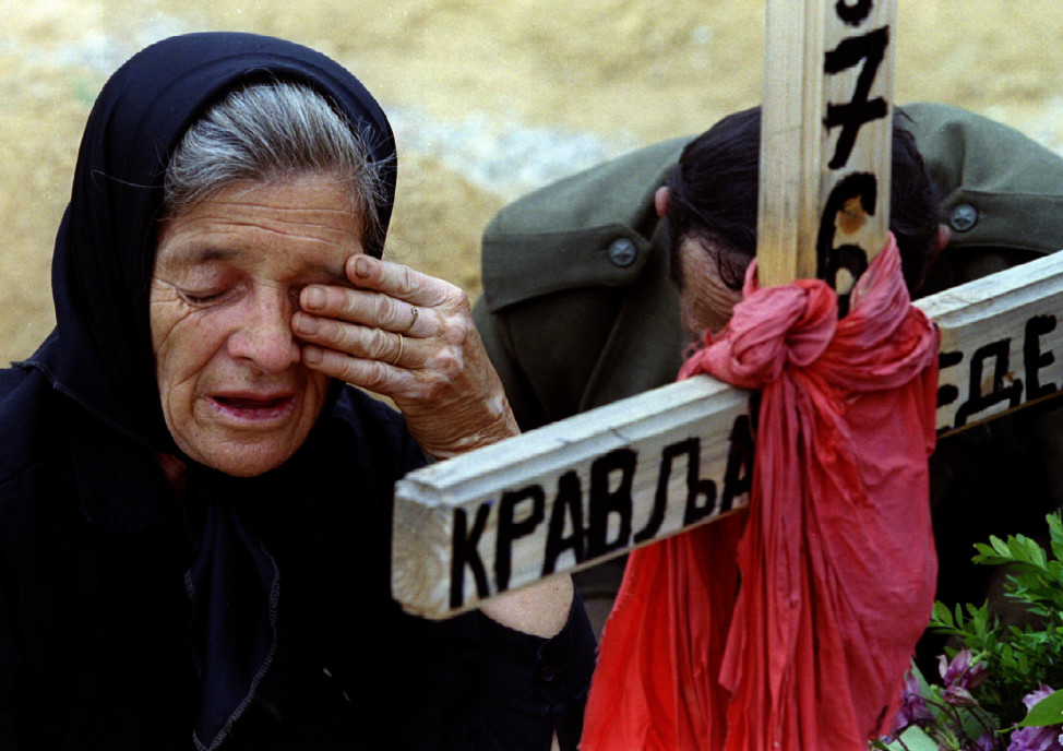 A woman weeps over the grave of her grandson in Sarajevo, a soldier in the Bosnian Serb forces, who was killed in 1993. (Reuters)