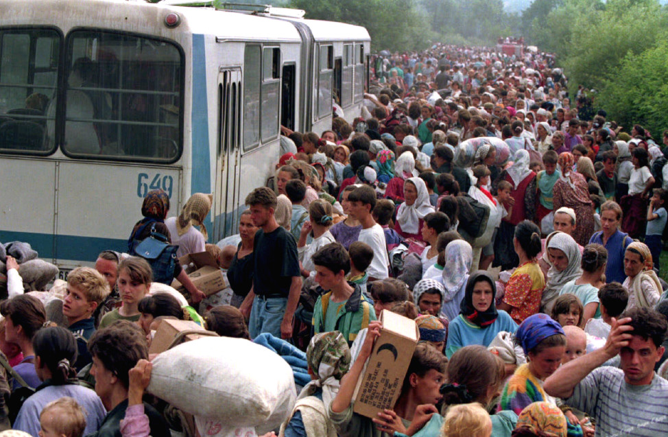 Around 10.000 refugees from Srebrenica board buses at a camp outside the UN base heading for other refugee camps in the Tuzla area on Bosnia-Herzegovina in July 1995 (Reuters)