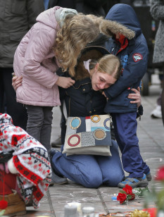 A woman consoles her children at a street memorial after the twin bomb attacks in Brussels on March 23, 2016. (Reuters)