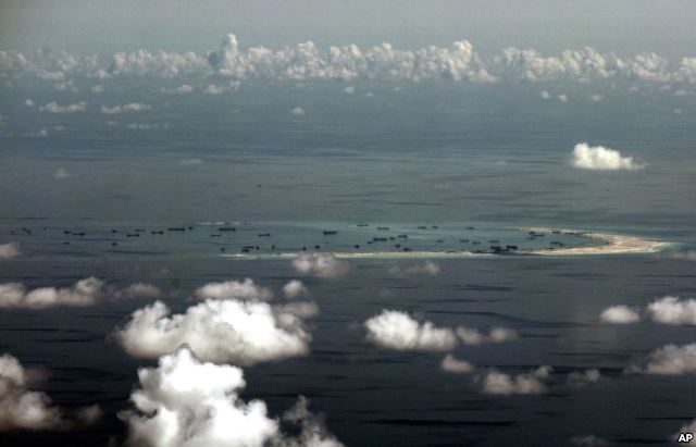 This aerial photo taken through a glass window of a military plane shows China's alleged on-going reclamation of Mischief Reef in the Spratly Islands in the South China Sea, May 11, 2015.