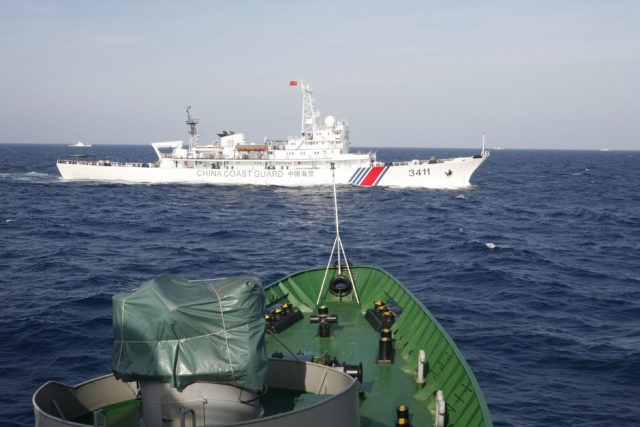 A ship (top) of Chinese Coast Guard is seen near a ship of Vietnam Marine Guard in the South China Sea, about 210 km (130 miles) off shore of Vietnam May 14, 2014. Vietnamese ships were followed by Chinese vessels as they neared China's oil rig in disputed waters in the South China Sea on Wednesday, Vietnam's Coast Guard said. Vietnam has condemned as illegal the operation of a Chinese deepwater drilling rig in what Vietnam says is its territorial water in the South China Sea. (Reuters)