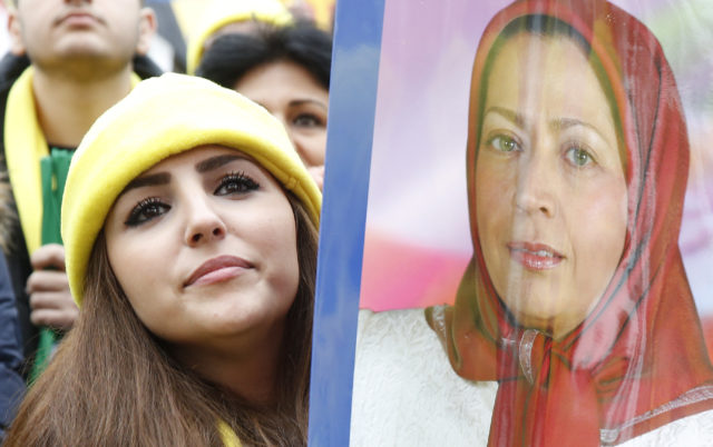 FILE - A demonstrator holds a placard showing a portrait of Maryam Rajavi, President of the National Council of Resistance of Iran (NCRI), during a protest against Iran's President Hassan Rouhani visit to France in central Paris, France, January 28, 2016.  (REUTERS) 