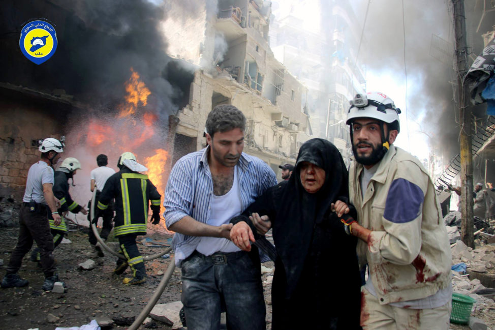 Residents trapped in rebel-controlled Aleppo are struggling to survive the crippling encirclement of their once thriving city. In this file photo taken on June 8, 2016, Syrian civil defense workers, right, helps an injured woman after warplanes attacked a street, in Aleppo, Syria. (Civil Defense Directorate in Liberated Province of Aleppo/AP)