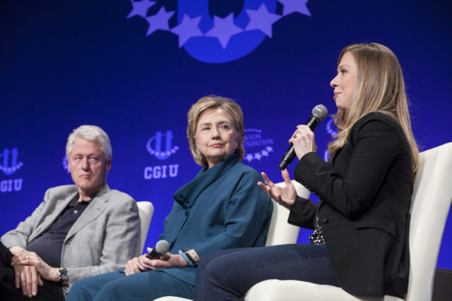 Former President Bill Clinton (L) and former Secretary of State Hillary Clinton (C) listen to their daughter and Vice Chair of the Clinton Foundation Chelsea Clinton during the second day of the 2014 Meeting of the Clinton Global Initiative at Arizona State University in Tempe, Arizona March 22, 2014. (Reuters) 