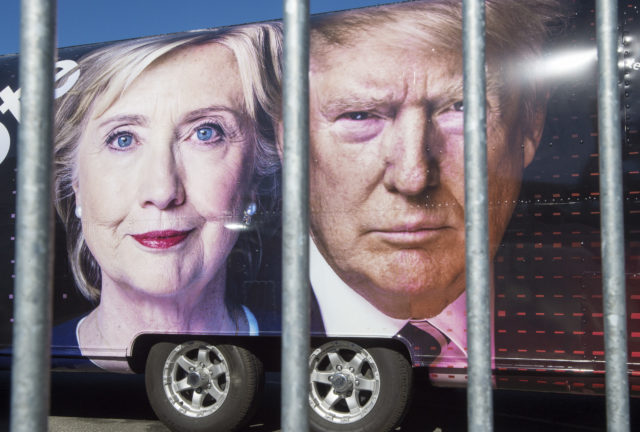 Large images of Democratic nominee Hillary Clinton and Republican nominee Donald Trump are seen on a CNN vehicle, behind a security fence, on Sept. 24, 2016, at Hofstra University, in Hempstead, New York, site of the first presidential debate on Sept. 26. (AFP) 