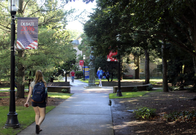 In this Sept. 23, 2016 photo, a student walks under a banner promoting the upcoming presidential debate on the campus of Hofstra University in Hempstead, N.Y. Hillary Clinton and Donald Trump will each take the debate stage on the campus for their highly-anticipated first face-off on Sept., 26. (AP) 