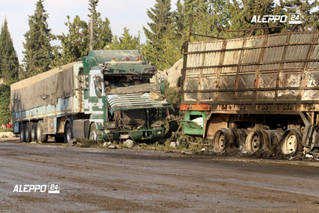 This image provided by the Syrian anti-government group Aleppo 24 news, shows damaged trucks carrying aid, in Aleppo, Syria, Sept. 20, 2016. A U.N. humanitarian aid convoy in Syria was hit by airstrikes Monday as the Syrian military declared that a U.S.-Russian brokered cease-fire had failed, and U.N. officials reported many dead and seriously wounded. (Aleppo 24 news via AP)