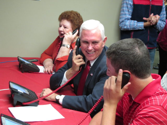 Republican vice presidential candidate Indiana Gov. Mike Pence makes phone calls along with campaign volunteers at a Republican party office on Sept. 27, 2016, in Fitchburg, Wis. (AP)