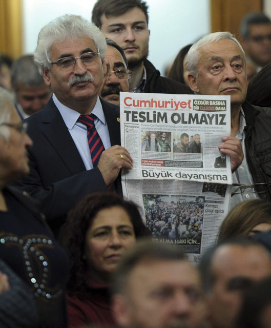 A man holds a latest copy of Cumhuriyet with a headline that reads "We Will Not Surrender" in Ankara, Tuesday, Nov. 1, 2016. Turkey's prime minister on Tuesday shrugged off the European Union's criticism on media freedoms, following the detentions of at least 13 senior staff members of an opposition newspaper. (AP)