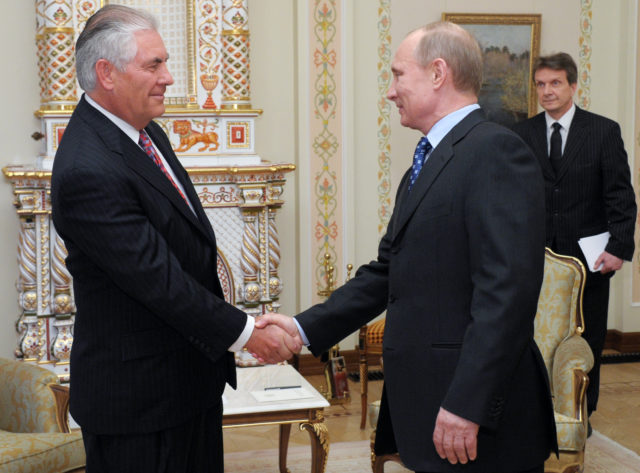 Russian Prime Minister Vladimir Putin, right, shakes hands with Rex W. Tillerson, chairman and CEO of Exxon Mobil Corporation at their meeting in the Novo-Ogaryovo residence outside Moscow, April 16, 2012. Exxon is teaming up with Russian oil giant Rosneft to develop oil and natural gas fields in Russia and North America. The companies signed an agreement that was first announced in August. (AP) 