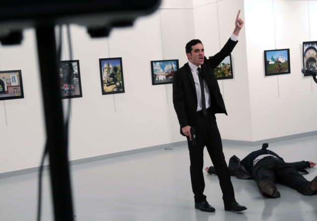 A man identified as Mevlut Mert Altintas shouts after shooting Andrei Karlov, the Russian Ambassador to Turkey, at a photo gallery in Ankara, Turkey, Dec. 19, 2016. Shouting "Don't forget Aleppo! Don't forget Syria!" Altintas fatally shot Karlov in front of stunned onlookers at a photo exhibit. (AP)