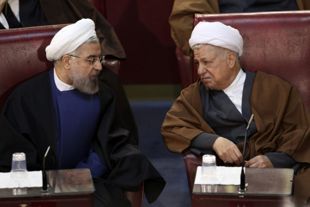 In this March 2014 photo, Iranian President Hassan Rouhani, left, and former President Akbar Hashemi Rafsanjani, who are members of the Assembly of Experts, confer in a biannual meeting of the assembly in Tehran, Iran. Rafsanjani died January 8 of a heart attack in Tehran. He was 82. 