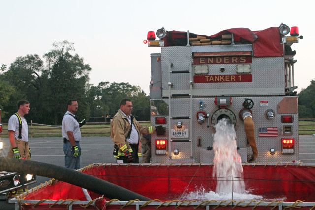 Volunteer Fire Chief Harold Rohde (far right) and volunteer firefighter Jacob Coon, at a fire training exercise at the Enders Fire Company in Berryville, Virginia. 