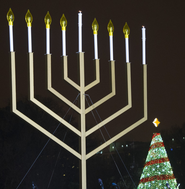 The National Christmas tree seen behind the National Menorah, on the Ellipse near the White House in Washington, Dec. 16, 2014. (AP)