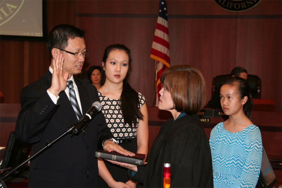 Andrew Do is sworn-in as supervisor of the 1st District of Orange County, California, by his wife, Judge Cheri Pham, Feb. 3, 2015.