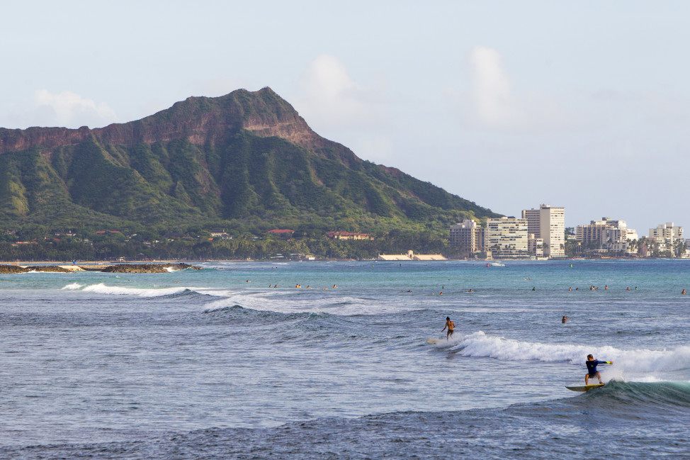 With Diamond Head mountain in the background, surfers hit the waves off Ala Moana Beach Park, in Honolulu, Hawaii.  (AP Photo)