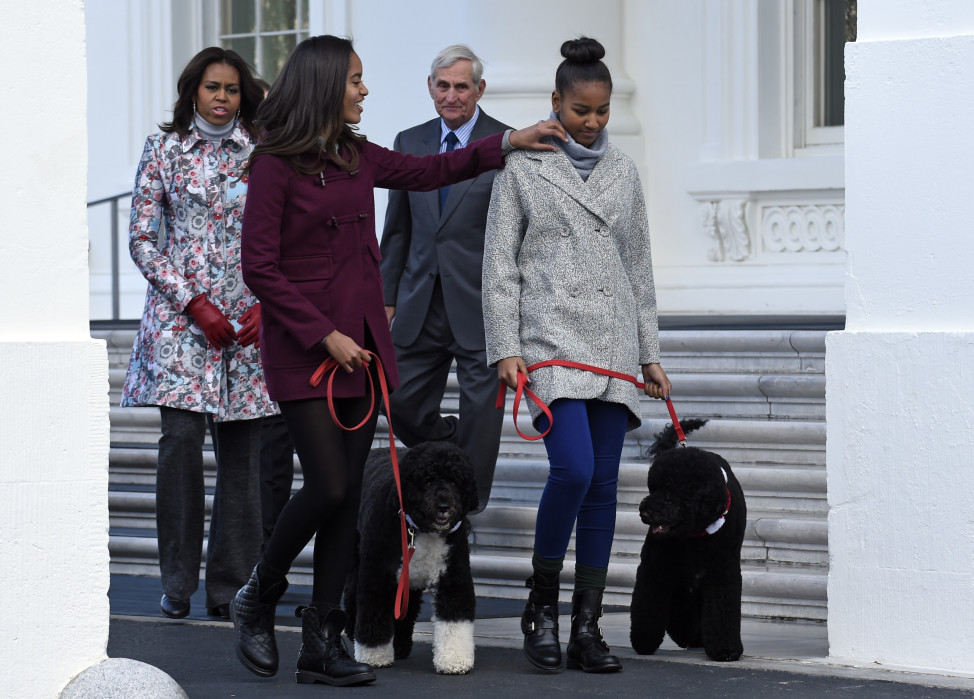 First Lady Michelle Obama, with daughters Malia and Sasha Obama, with the family dogs, Bo and Sunny, at the White House in November 2014. (AP Photo)