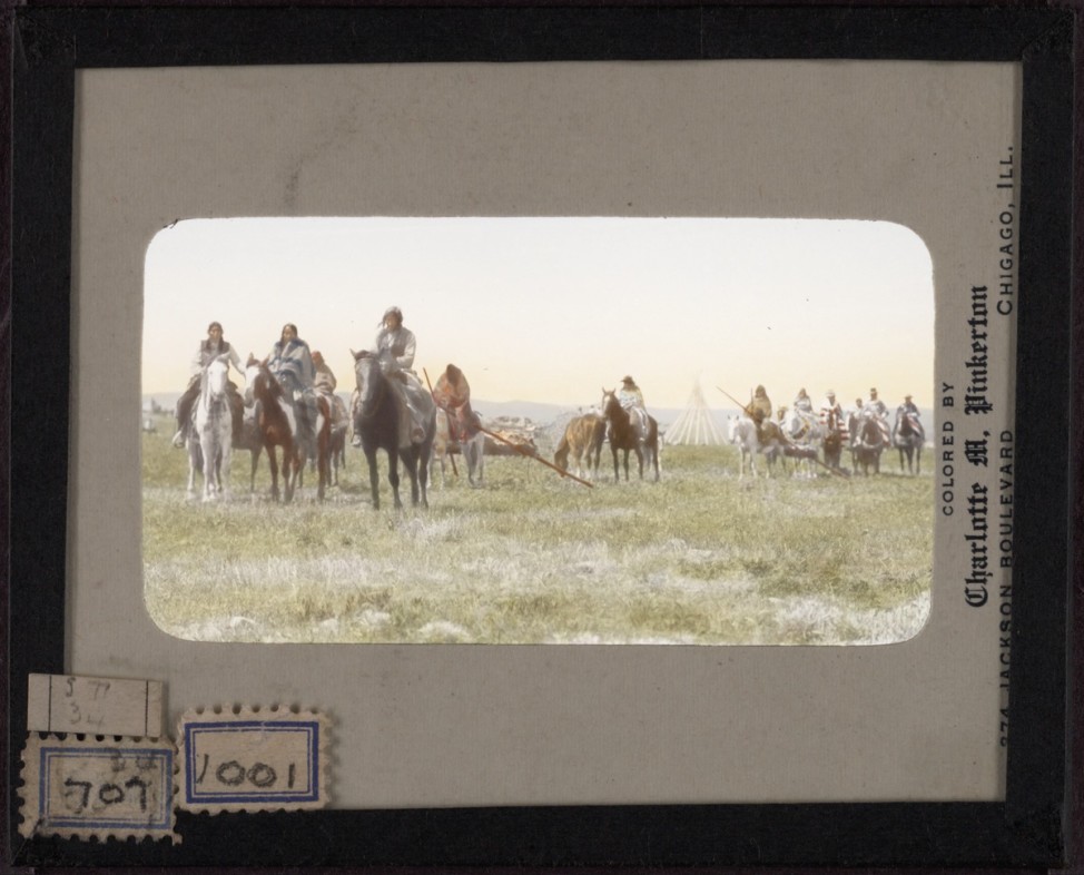 Indians on horseback in the country of the South Piegan. Hand-painted lantern slide by photographer Walter McClintock (1870-1949) of the Blackfoot Indians of Montana. (Yale Collection of Western Americana, Beinecke Rare Book and Manuscript Library) 