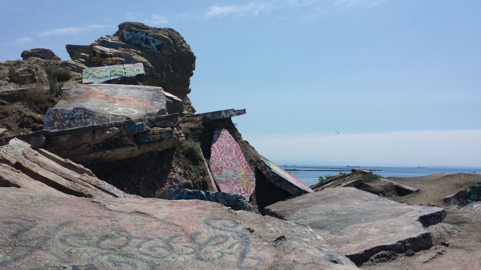 Graffiti adorns some of Sunken City’s buckled roads and sidewalks, July 11, 2015. (Photo by Flickr user Jon May via Creative Commons license)