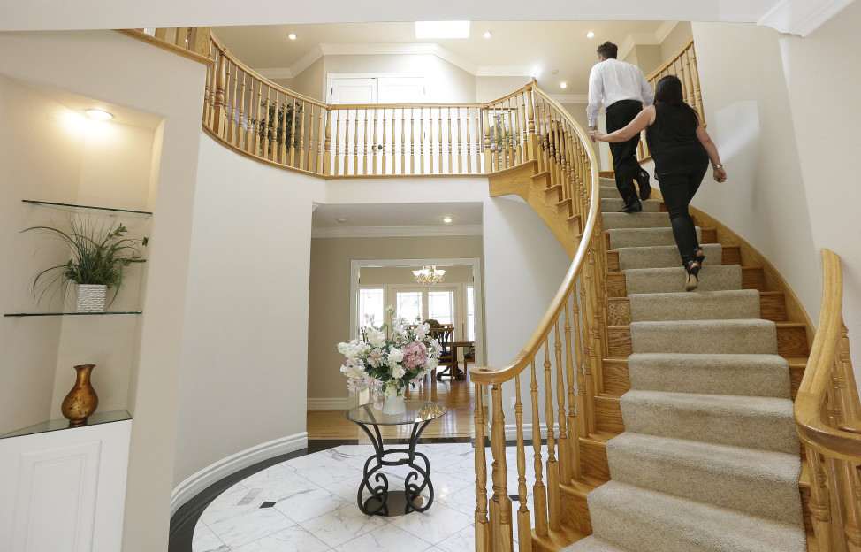 In this May 6, 2015 photo, a realtor (top) shows a potential buyer a home for sale in Pacifica, California. Just 32 percent of people surveyed viewed the real estate profession as prestigious. (AP Photo) 