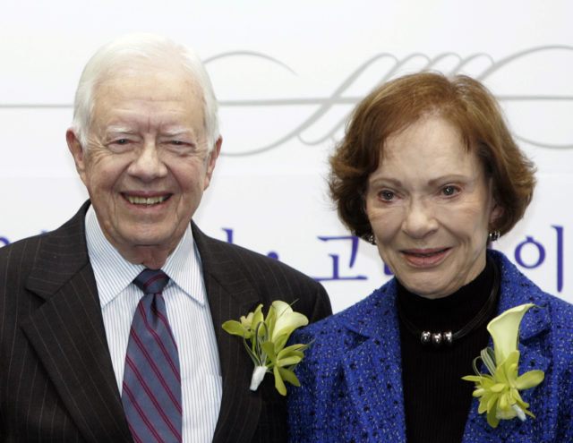 Former U.S. President Jimmy Carter and his wife Rosalynn pose during an event at the Cyber University of Korea in Seoul March 22, 2010. The event was held to sign a partnership between the Rosalynn Carter Institute at Georgia Southwestern State University and the Caregiving Center at the Cyber University of Korea. Jimmy Carter will receive an honorary doctorate in politics from Korea University on Tuesday. REUTERS/Truth Leem (SOUTH KOREA - Tags: EDUCATION POLITICS) - GM1E63M12TC01