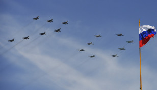 Mikoyan-Gurevich MiG-29 Fulcrum fighters and Sukhoi Su-25 Frogfoot ground-attack planes form a number 70 as they fly over the Red Square during the Victory Day parade in Moscow