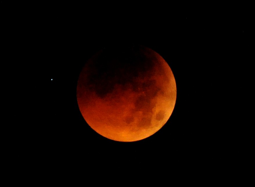 The moon is partially covered as a lunar eclipse gets underway, as seen from the Philippine Observatory in Manila before dawn. Astronomers in parts of Europe, Africa, Central Asia and Australia were hoping for clear skies to enjoy a total lunar eclipse, the first of 2011 and the longest in nearly 11 years. (AFP Image)