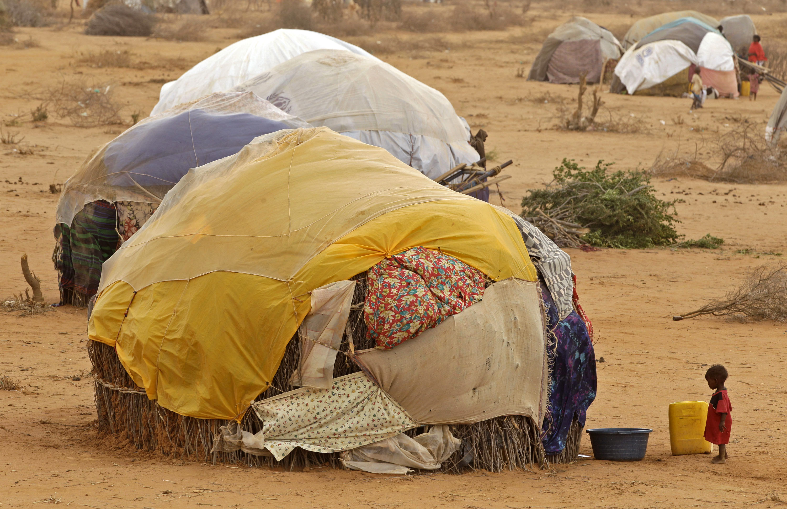 A child stands in front of her home at a refugee camp in Dadaab, Kenya ...