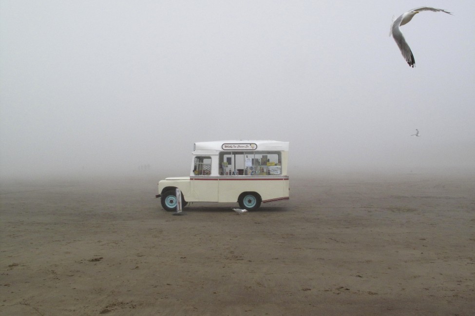 An ice cream van stands on a foggy beach in Whitby, northern England July 7, 2012. (Reuters)