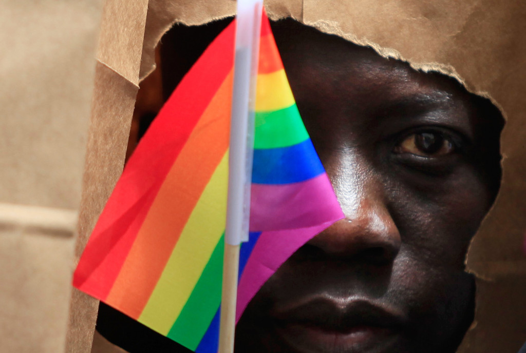 An asylum seeker from Uganda covers his face with a paper bag in order to protect his identity as he marches with the LGBT Asylum Support Task Force during the Gay Pride Parade in Boston, Massachusetts June 8, 2013.