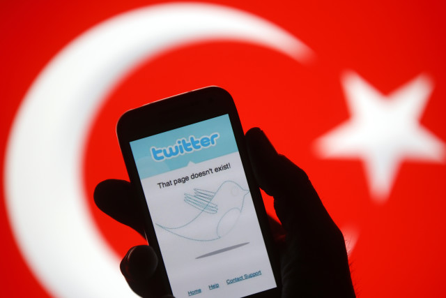 Person holds a Samsung Galaxy S4 displaying a Twitter error message in front of Turkish national flag in this illustration taken in Zenica