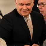 Dmitry Kiselyov,  the head of media conglomerate Rossiya Segodnya (Russia Today) smiles as he attends a joint session of Russian parliament on Crimea's incorporation into Russia at the Kremlin in Moscow on March 18, 2014.  AFP PHOTO / KIRILL KUDRYAVTSEV