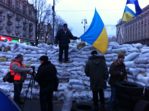 The pro-Europe Maidan has become a huge magnet for Kyiv residents. Here a man poses on barricade that blocks Kreschatyk,  the capital's central avenue. VOA Photo: James Brooke