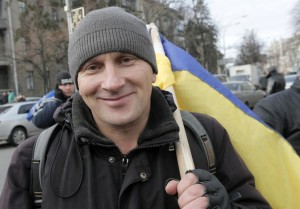 Leonid from Lviv traveled halfway across Ukraine to demonstrate in favor of Ukraine moving closer to the European Union. AP Photo: Efrem Lukatsky 