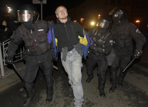 In the pre-dawn darkness of Nov. 30, rriot police used tear gas and clubs to clear Kyiv's Maidan or Independence Square. Photo: AP/Sergei Chuzatkov