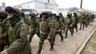 Russian soldiers march through Crimea's capital Simferopol, the day before Crimeans were to vote on joining Russia. Photo: Reuters