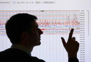 A seismologist points to a seismographic graph showing the magnitude of the earthquake in Japan, March 11, 2011.  (Photo: REUTERS/David Moir)