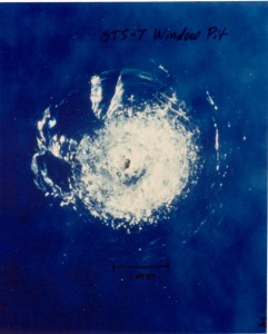 A tiny piece of space junk (a paint fleck) damaged the window of the space shuttle during the STS-7 mission (Photo: NASA Orbital Debris Program Office)