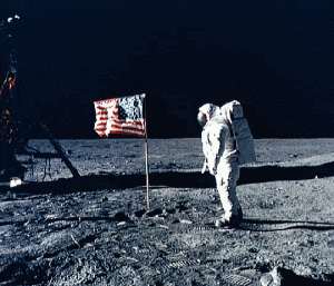 Astronaut Edwin "Buzz" Aldrin Jr., Apollo 11 lunar module pilot stands beside the U.S. flag that he and Neil Armstrong had planted on the moon during the very visit by man to the lunar surface (Photo: NASA)