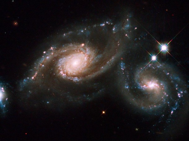 From the Hubble Space Telescope - Two spiral galaxies are squaring off in the constellation of Virgo. When two galaxies collide, the stars that compose them usually do not. This is because galaxies are mostly empty space. (Photo: NASA, ESA, M. Livio (STScI) and the Hubble Heritage Team (STScI/AURA))