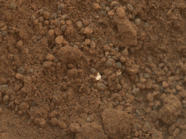 A bright particle of material found in a hole dug by the Curiosity Martian rover caused a bit of concern at NASA’s Jet Propulsion Laboratory because another similar object, found nearby, was identified as a piece of debris from the spacecraft.  However, the mission's science team assessed the bright particles in this scooped pit to be native Martian material rather than spacecraft debris. (Photo: NASA/JPL-Caltech/MSSS)