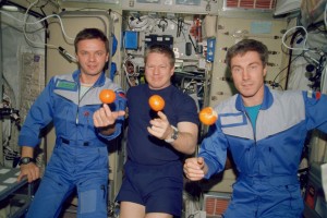 First humans aboard the International Space Station 11/2000 - the Expedition One crew about to enjoy a snack. From the left, are cosmonaut Yuri P. Gidzenko, Soyuz commander; astronaut William M. Shepherd, mission commander; and cosmonaut Sergei K. Krikalev, flight engineer. (Photo: NASA)