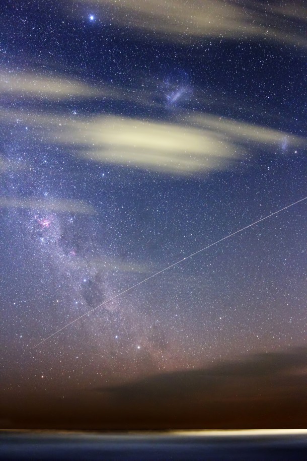 This is a single 5 minute exposure taken recently in Buenos Aires on an Argentinian summer night.  It shows not only Earth clouds but starry clouds, the pinkish glow of the Carina Nebula, and Small Magellanic Clouds.  The line arcing from the center of the right side to the lower left is the orbiting International Space Station. (Photo & Copyright: Luis Argerich)