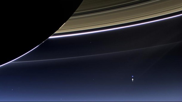 This image taken by the wide-angle camera on NASA's Cassini spacecraft, on July 19, 2013, has captured Saturn's rings and our planet Earth (arrow) and its moon in the same frame. (NASA/JPL-Caltech/Space Science Institute)